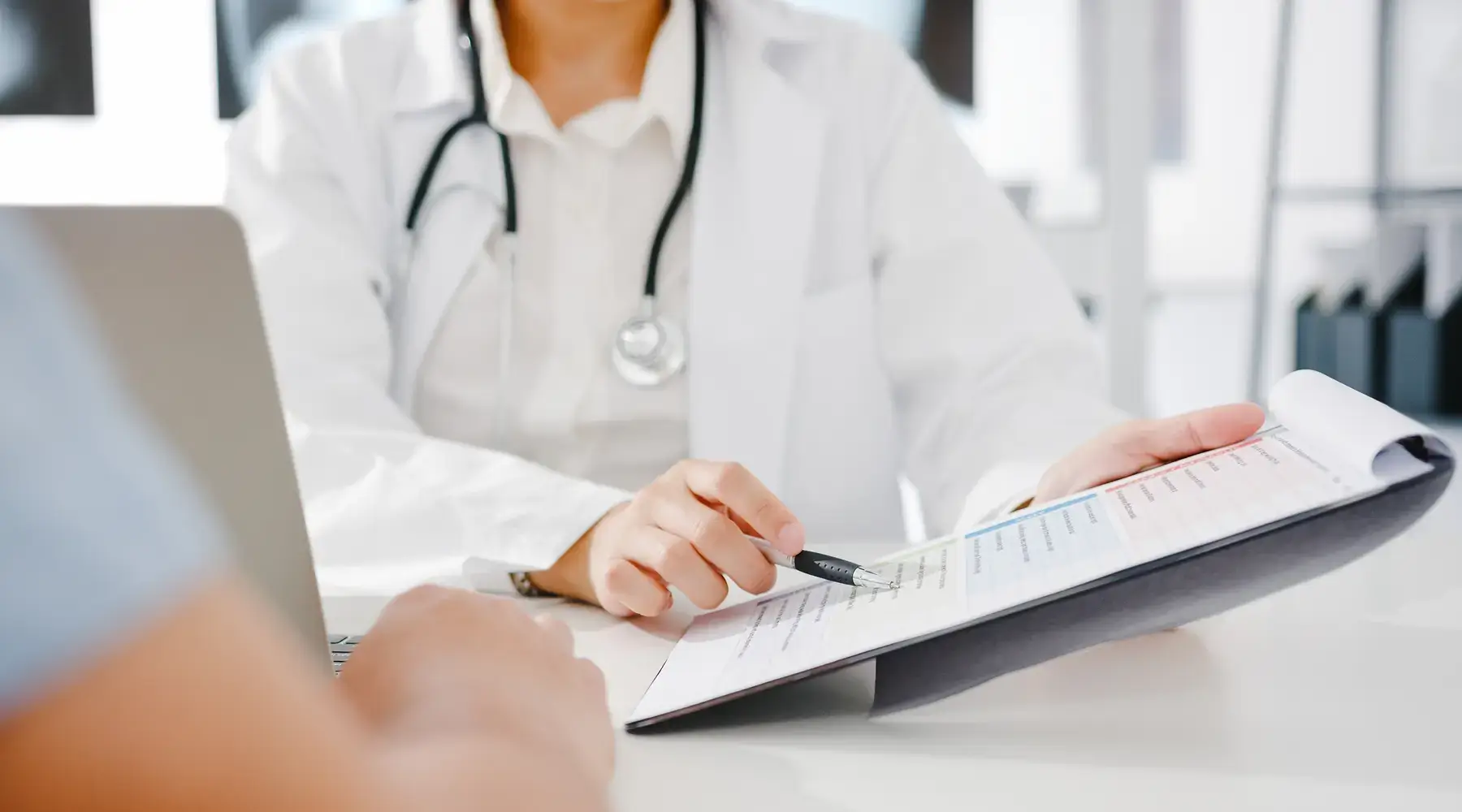 Top 10 Best Rare Disease Clinical Trial Recruitment Companies 2026 Doctor reviewing a patient eligibility chart during a clinical trial consultation