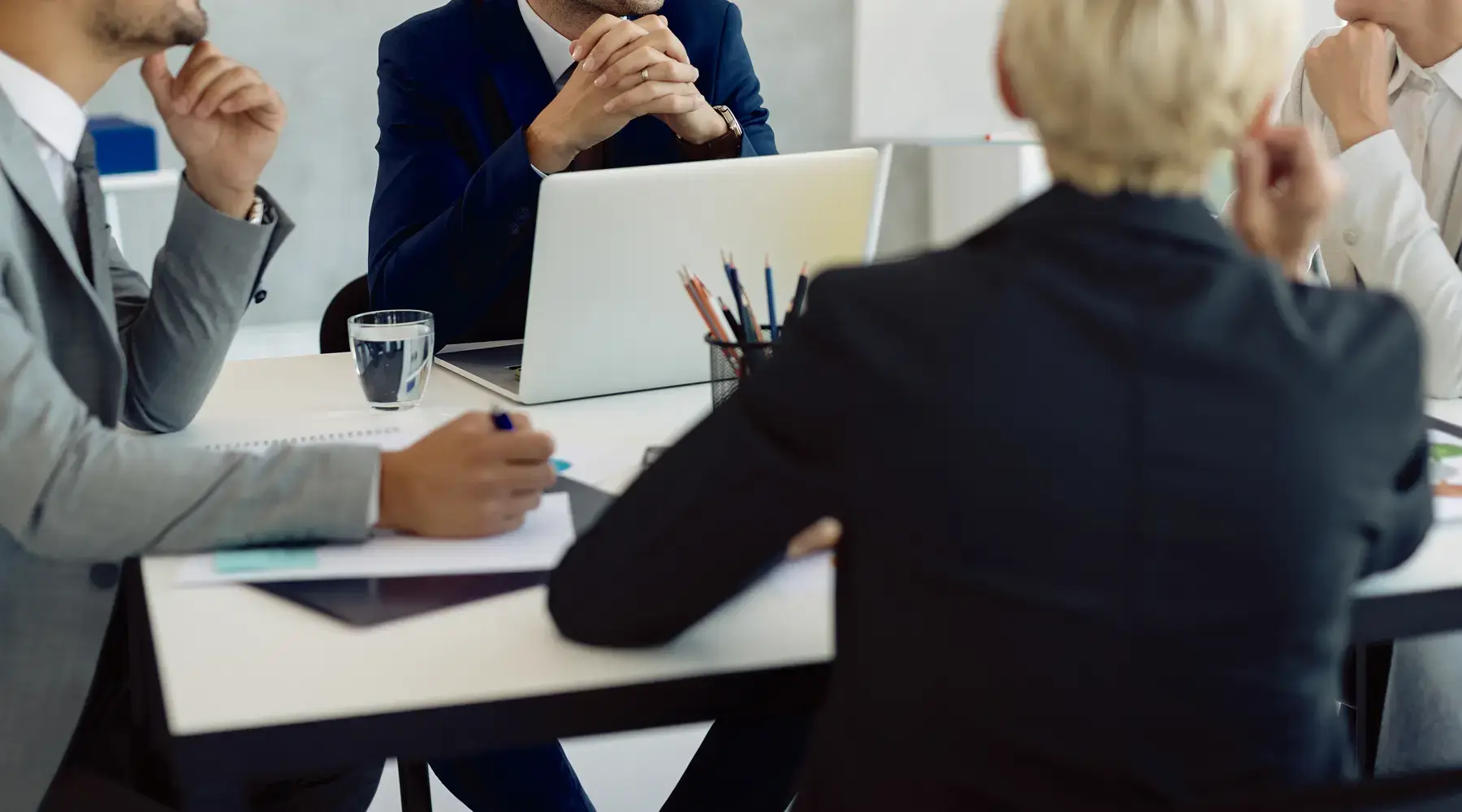 Clinical Trial Recruitment Tools for Digital Patient Recruitment 2026 Marketing team in a meeting around a table with a laptop and documents