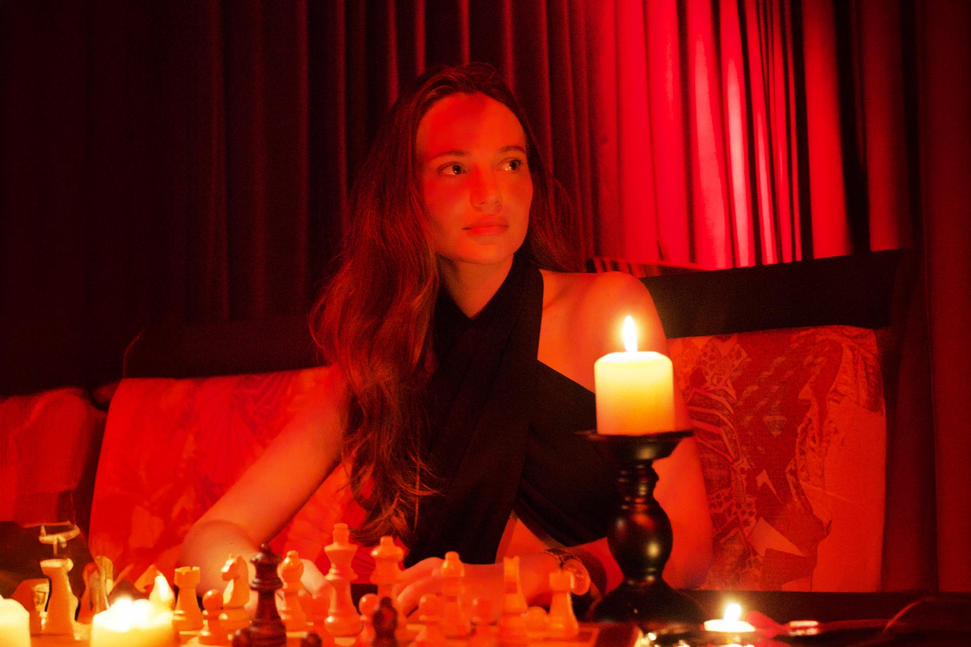 Guest at a red-lit FERZ speakeasy chess night