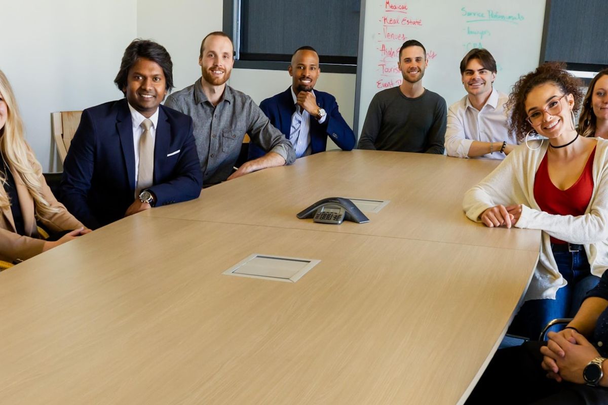 group of people sitting on chair in front of brown wooden table