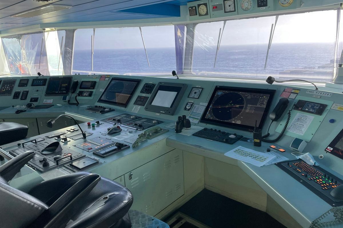 the control room of a ship with multiple monitors