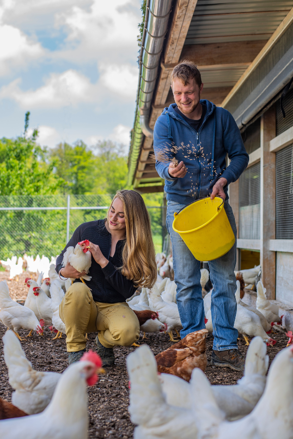 Manuela and Noa feeding the chickens from Biohof