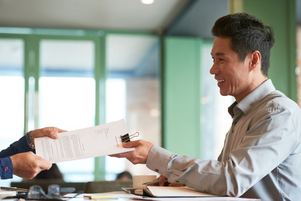 A man handing permits