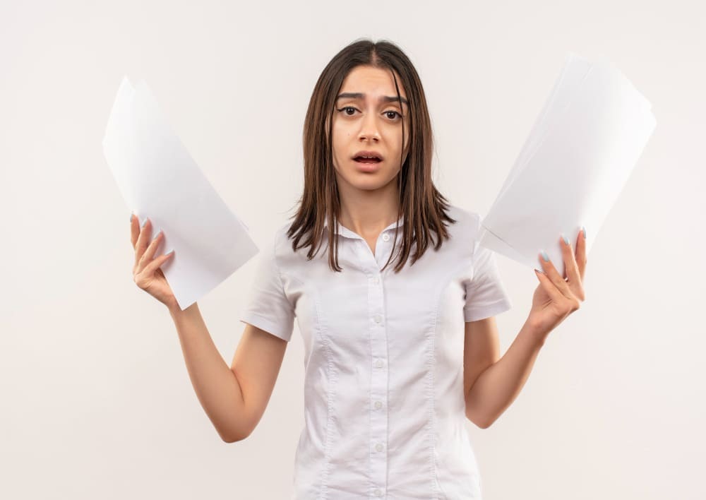 A lady in white holding papers