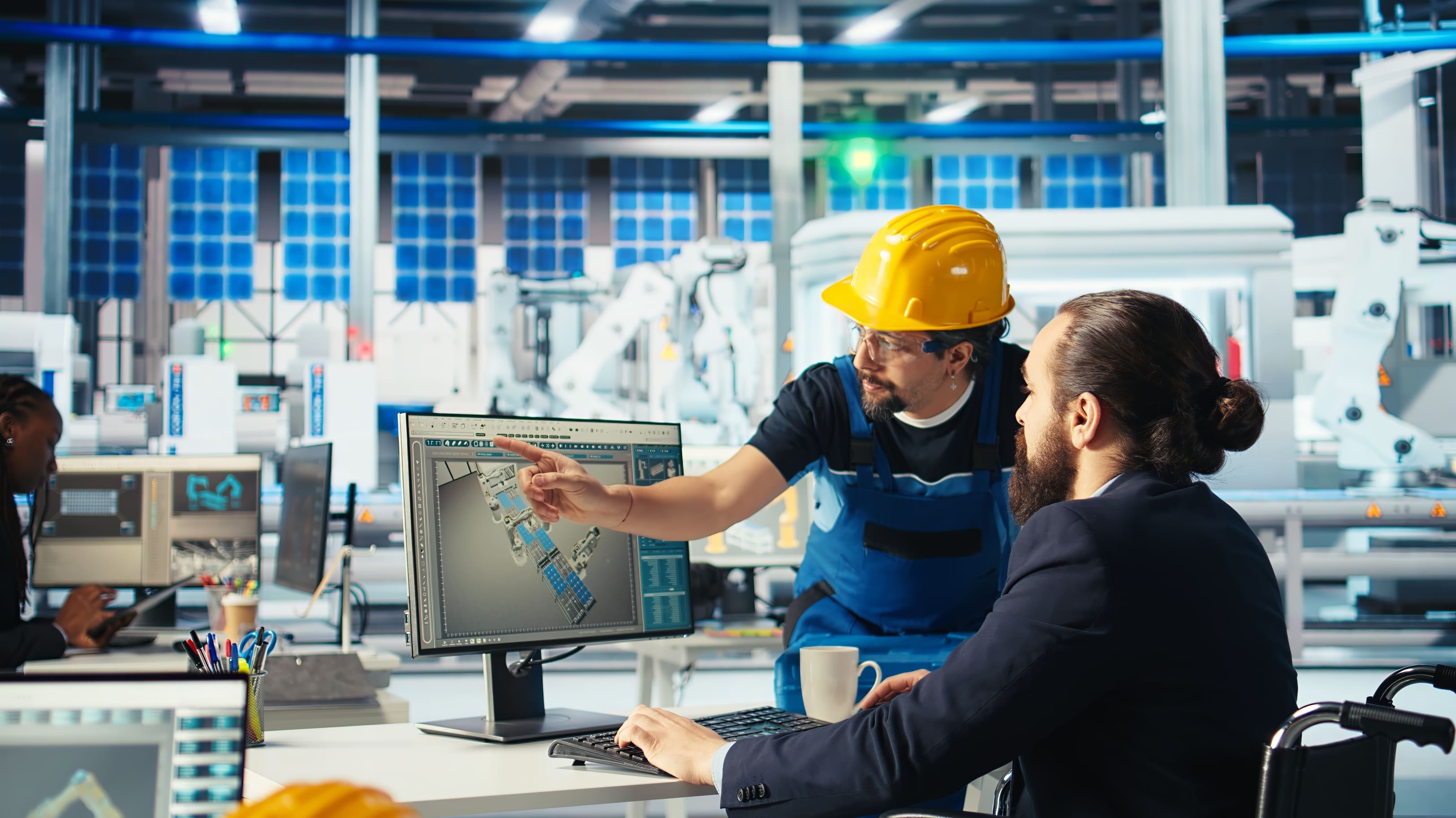 Engineers discussing manufacturing blueprint accessibility inclusion