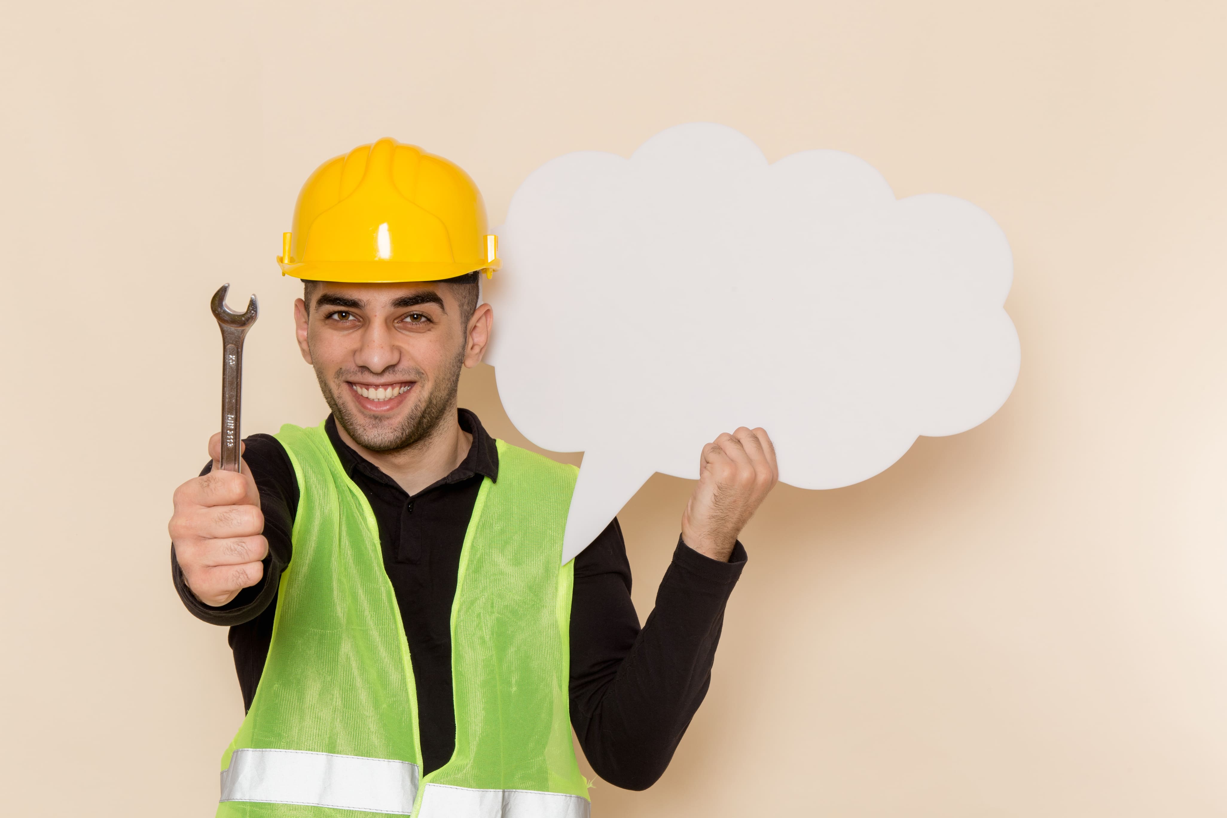 Front view male builder in yellow helmet