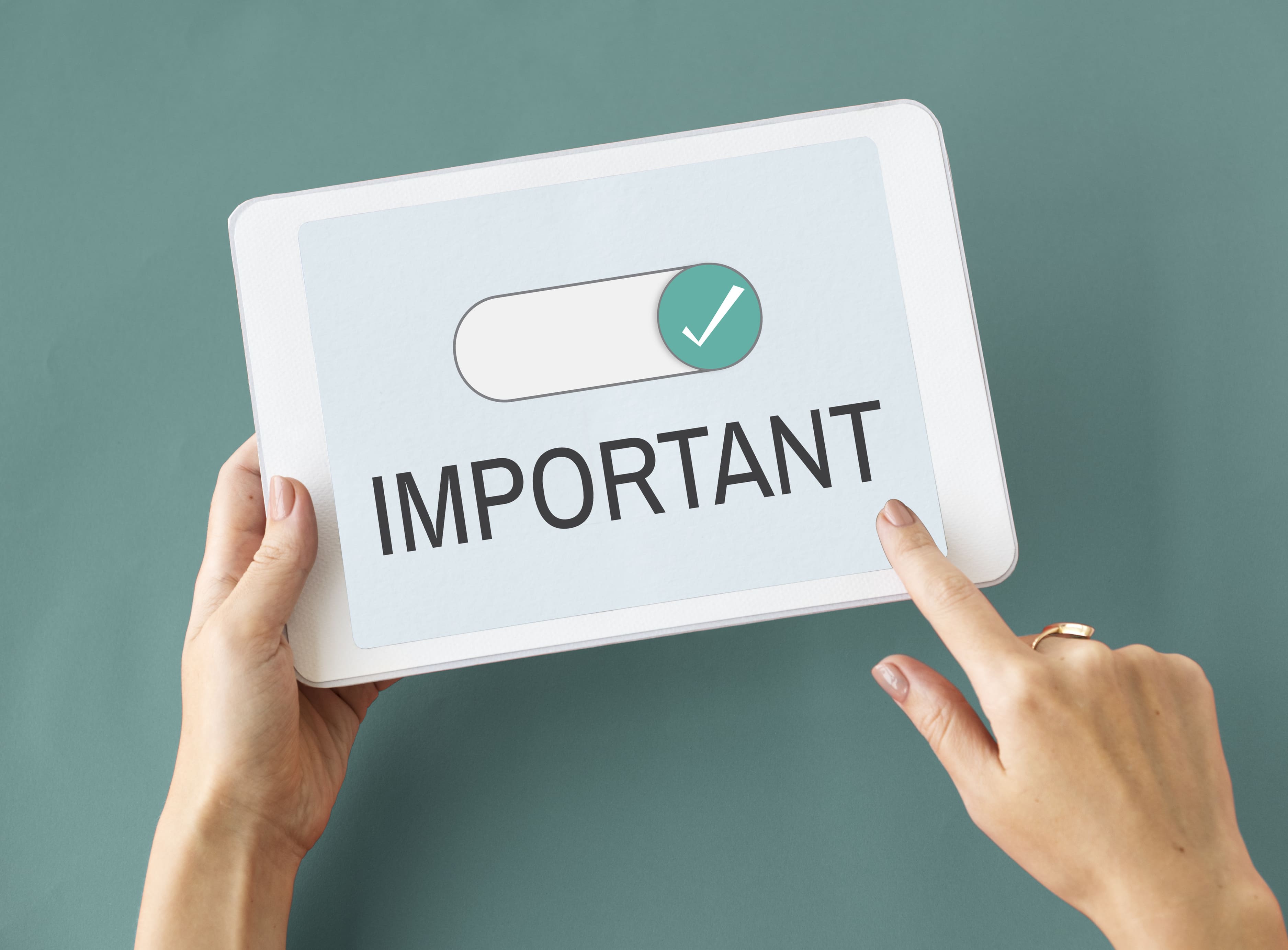 Hands tapping screen to mark task as important