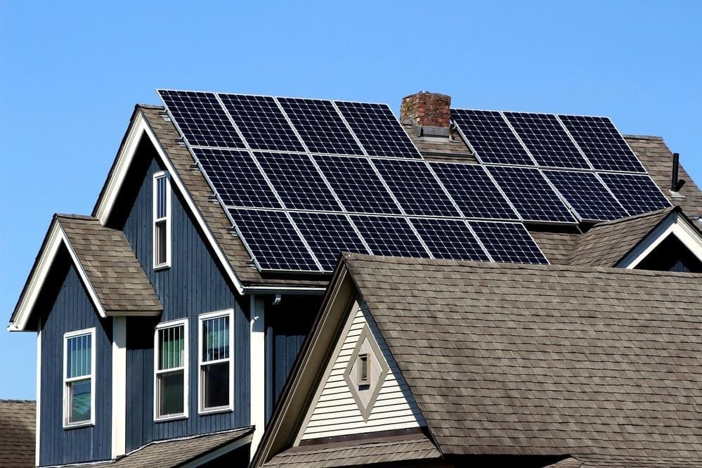 Modern residential home with solar panels installed on roof