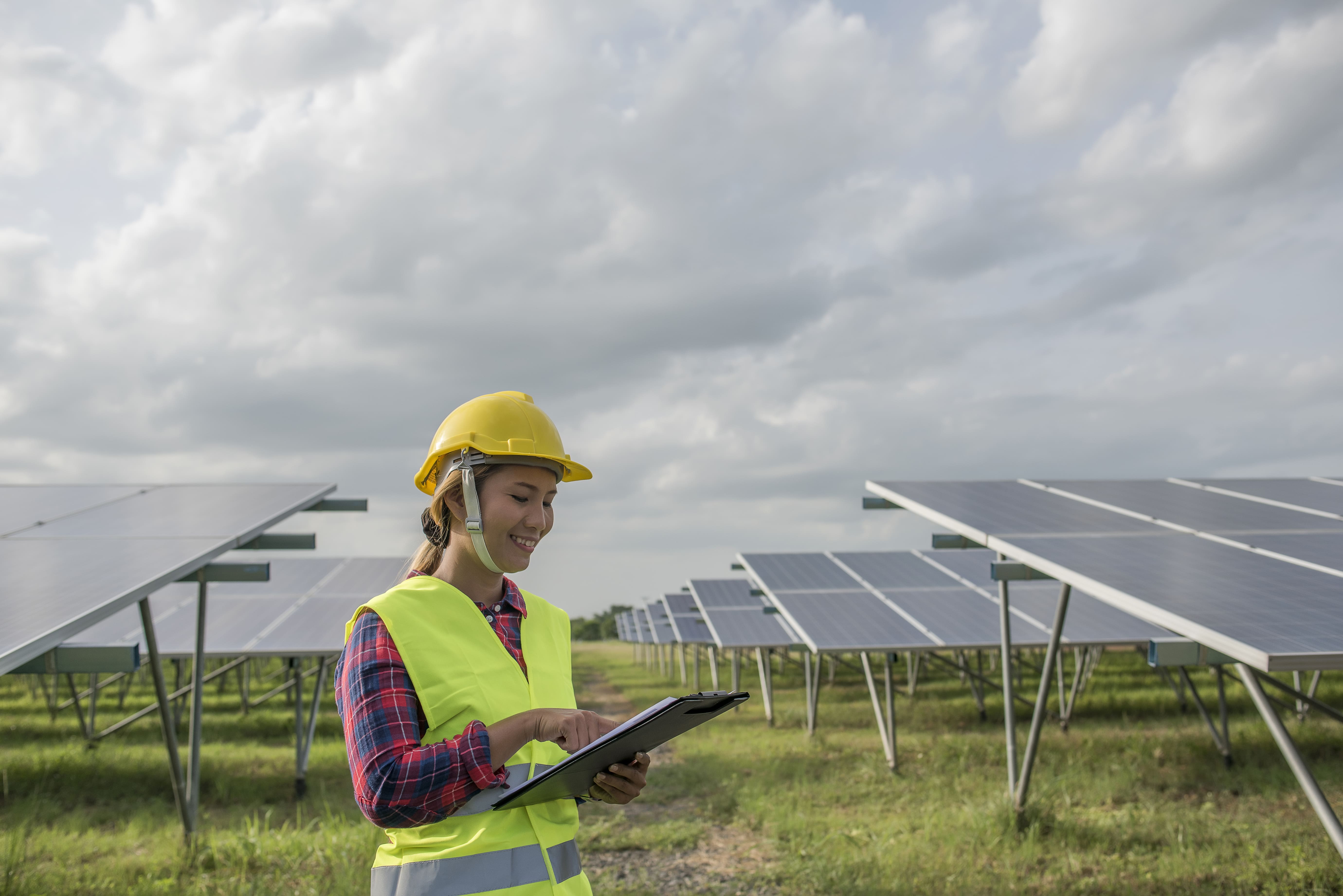 Engineer woman checking and maintenance of solar cells
