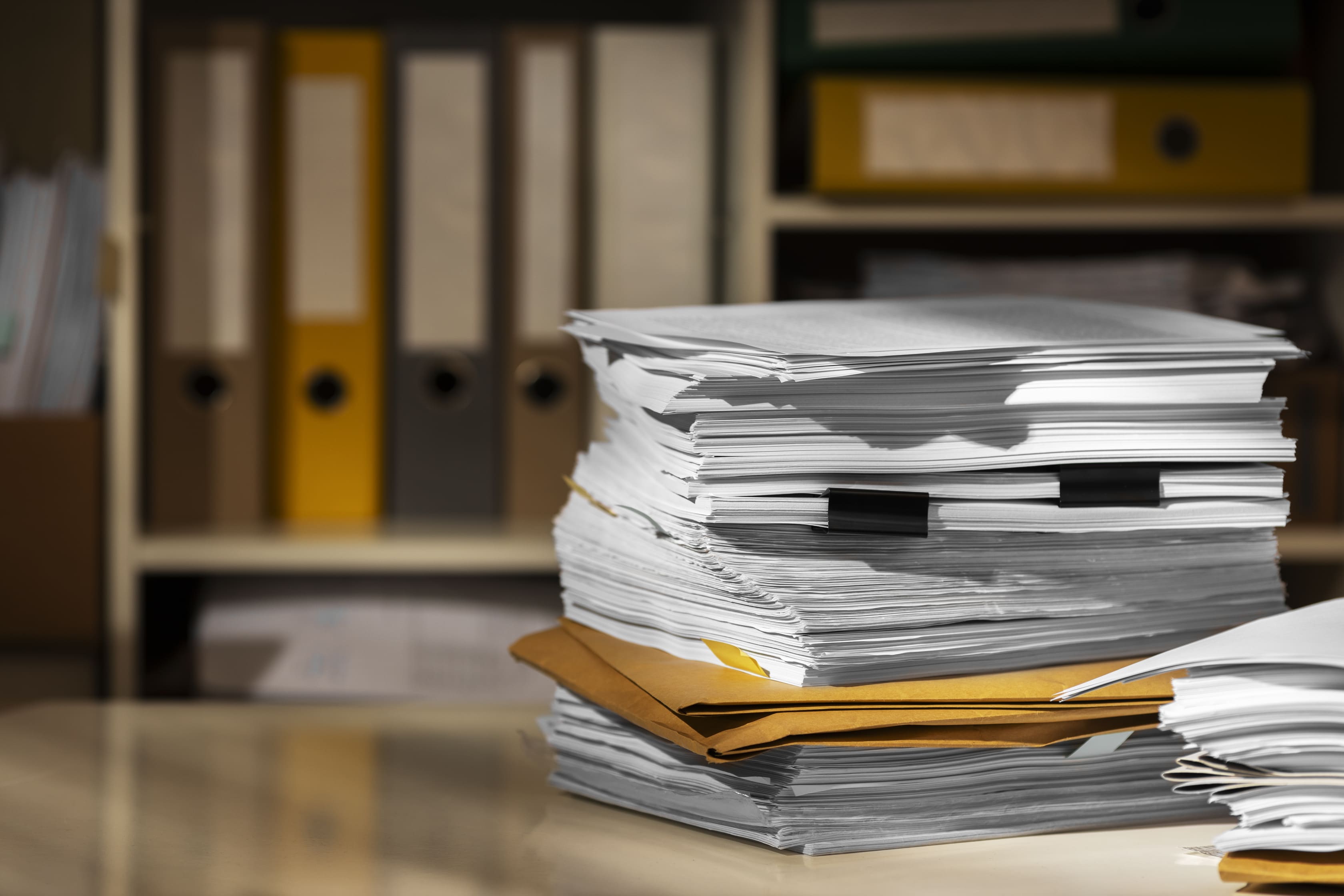 Stack of organized documents and files on a desk