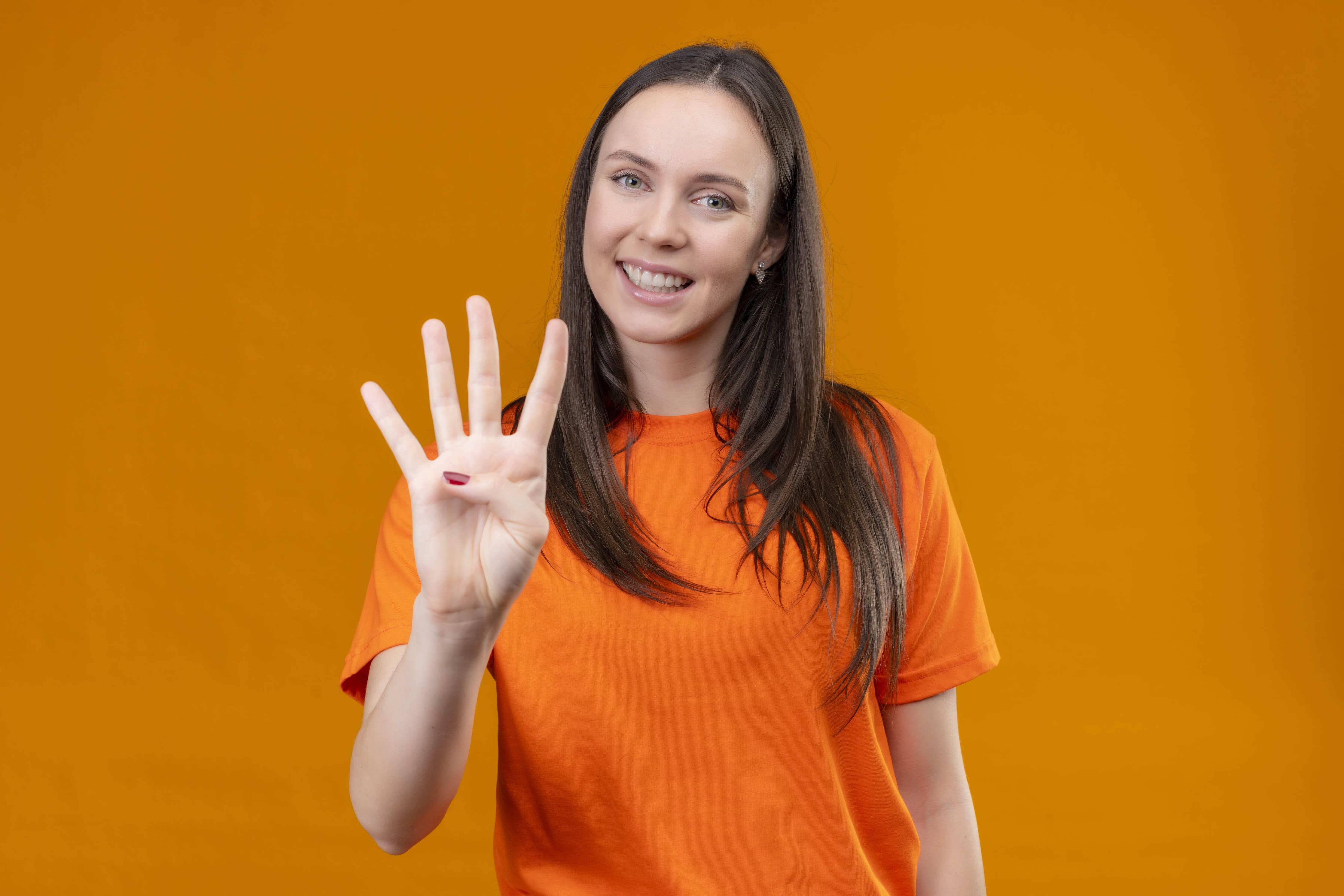 Young beautiful girl wearing orange t-shirt