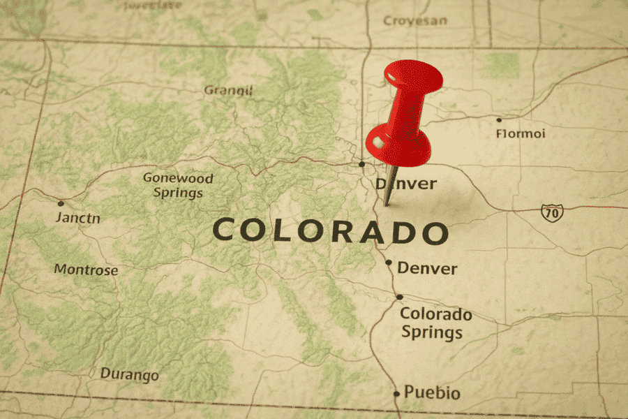 A male electrician works in a switchboard