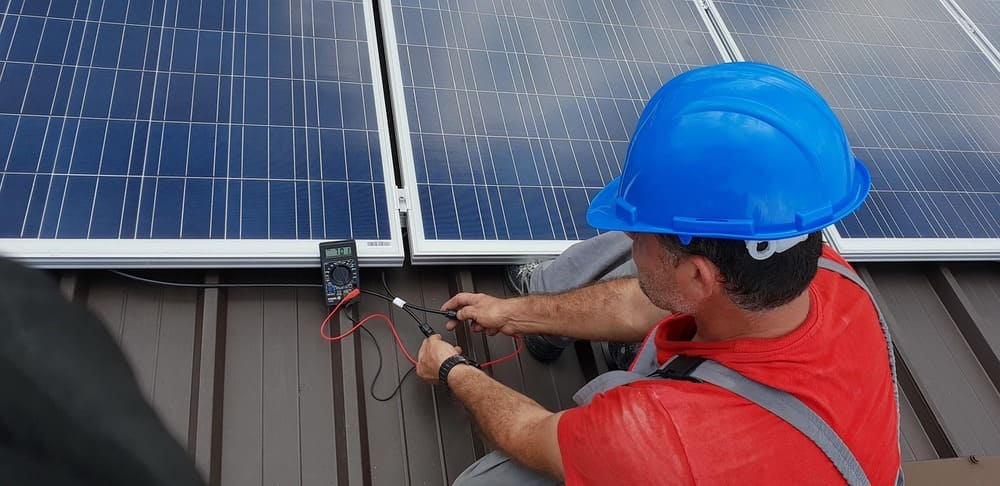 solar installer checking on solar panel