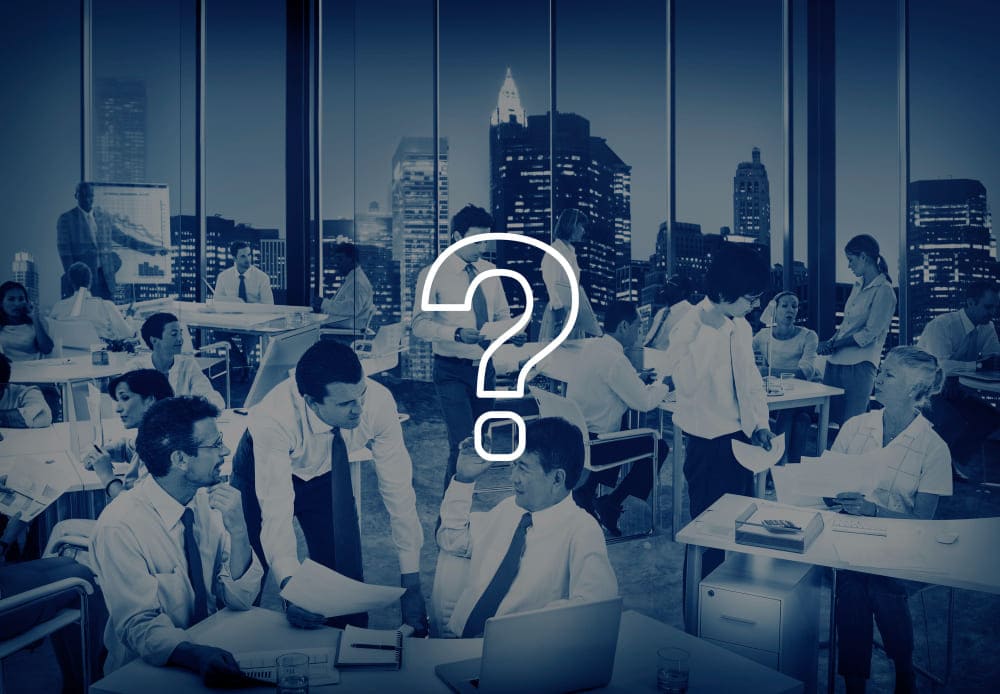 question mark with background of discussing professionals