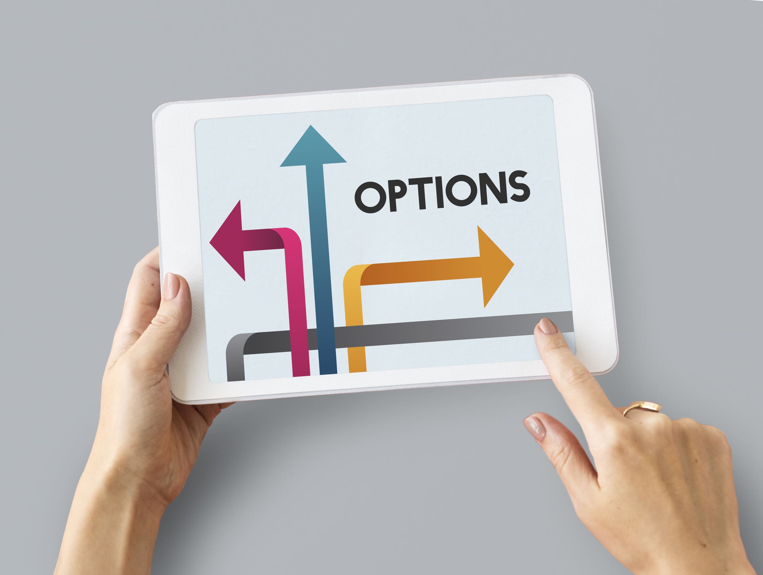 Hands hold tablet showing OPTIONS with directional arrows