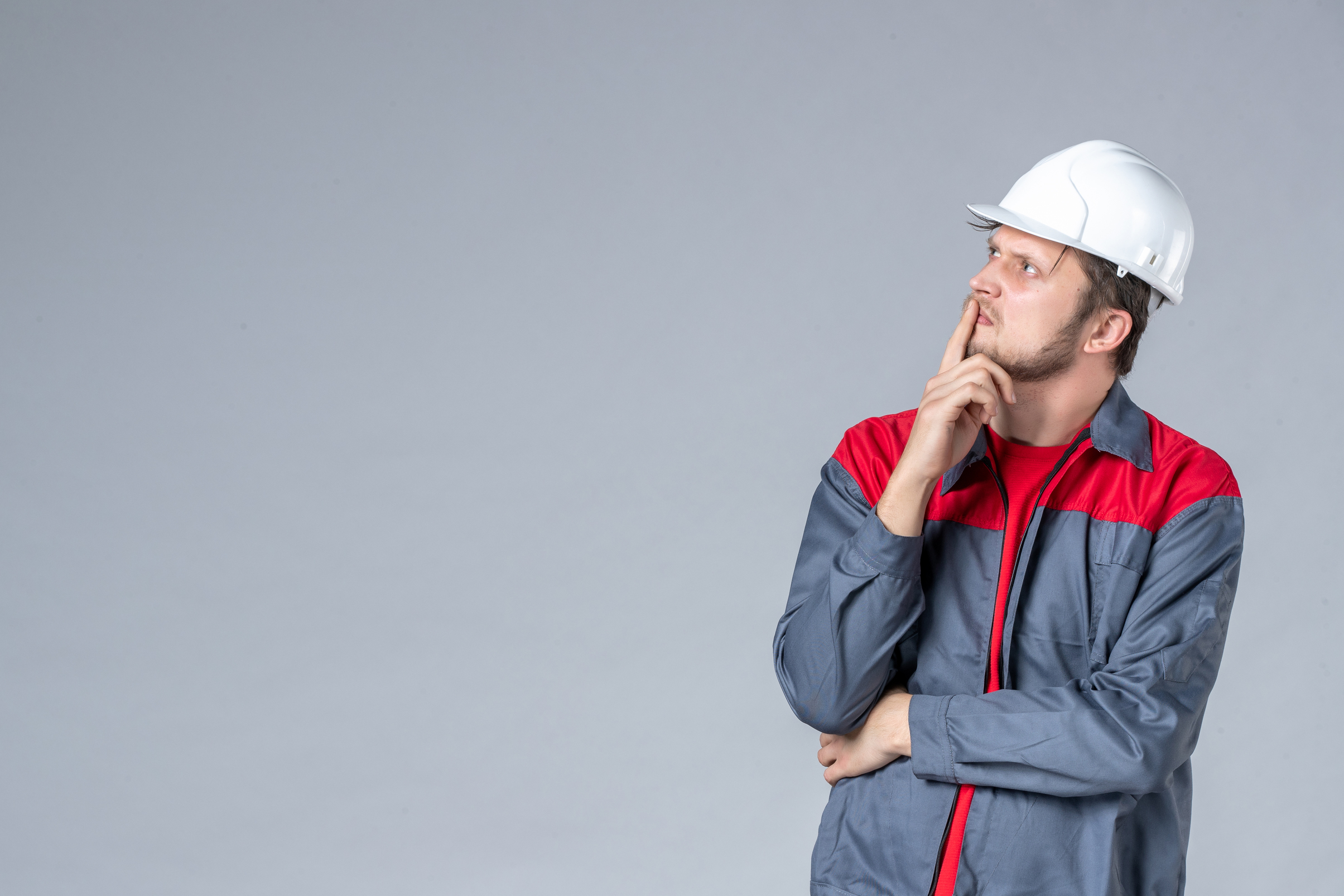 Thoughtful construction worker considers project problem