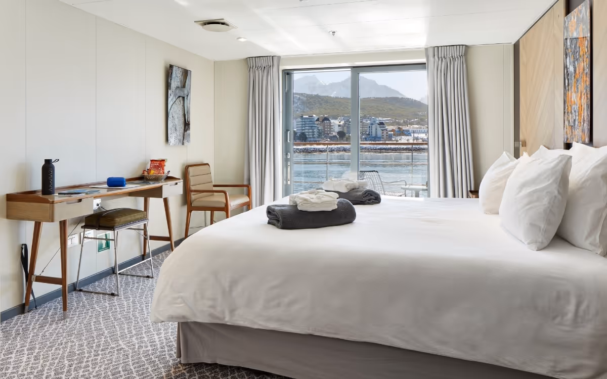 Deluxe Veranda Cabin with a double bed onboard Antarctica21's Magellan Explorer in Antarctica