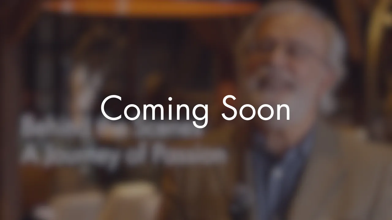 Blurred background of an older man smiling indoors with the text 'Coming Soon' overlaid.