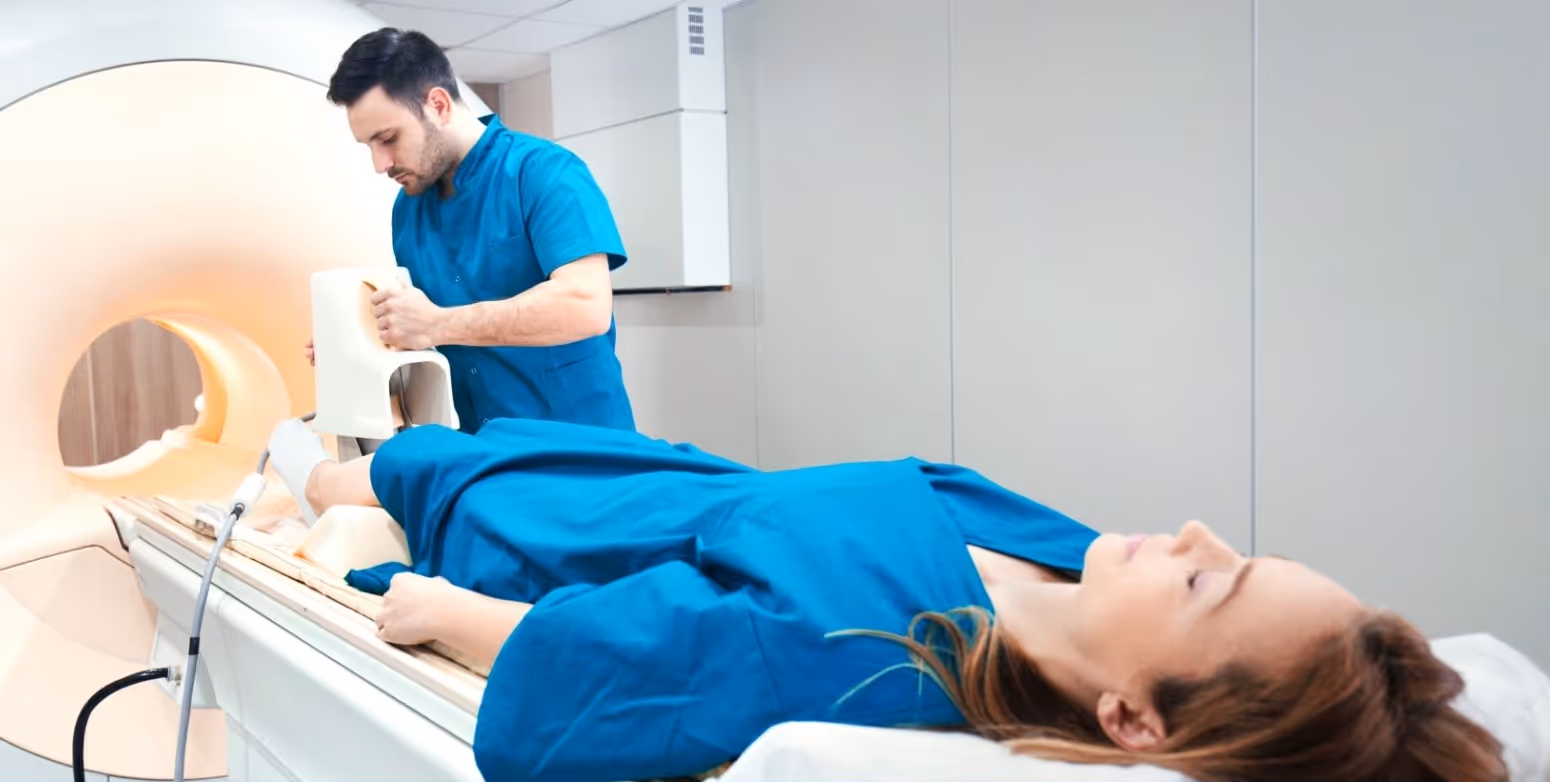 Patient lying supine (on their back) fee-first toward the MRI scanner, with dedicated foot coil array on their right ankle