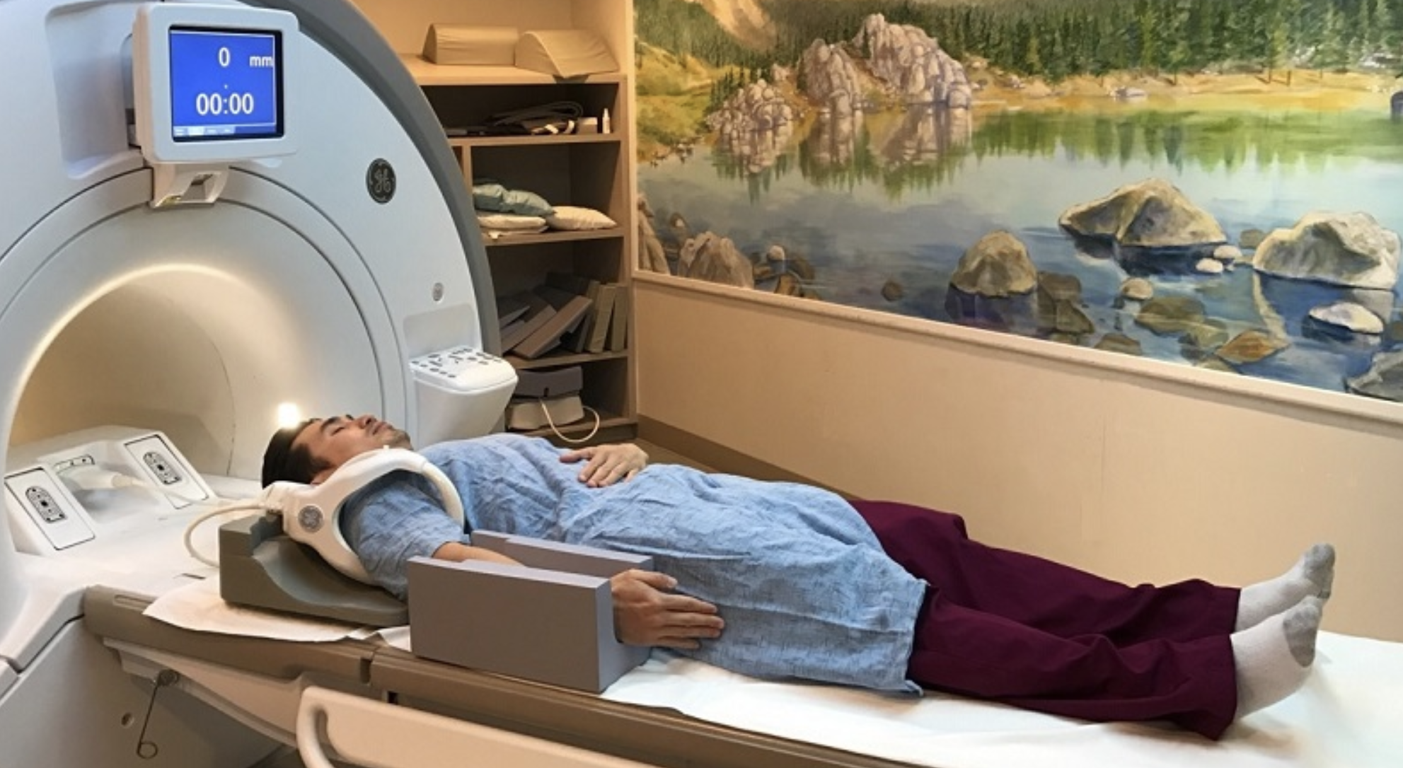 Patient lying supine (on their back) head-first toward the scanner bore with a dedicated shoulder coil