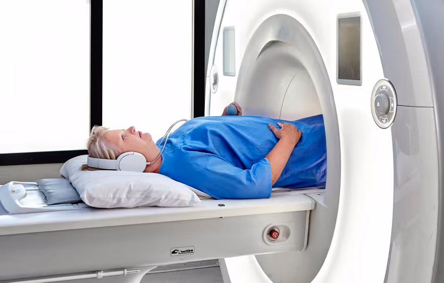 Patient lying on their back (supine) with their feet first toward the MRI scanner bore