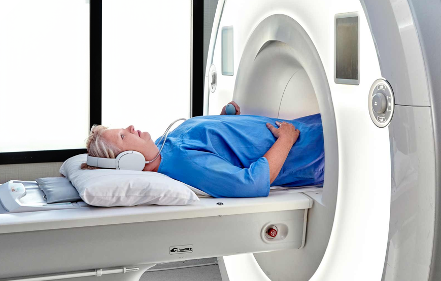 Patient lying on their back (supine) with their feet first toward the MRI scanner bore
