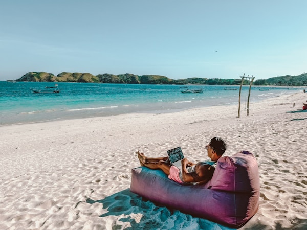 Relaxing on a beach in Lombok with my laptop out.
