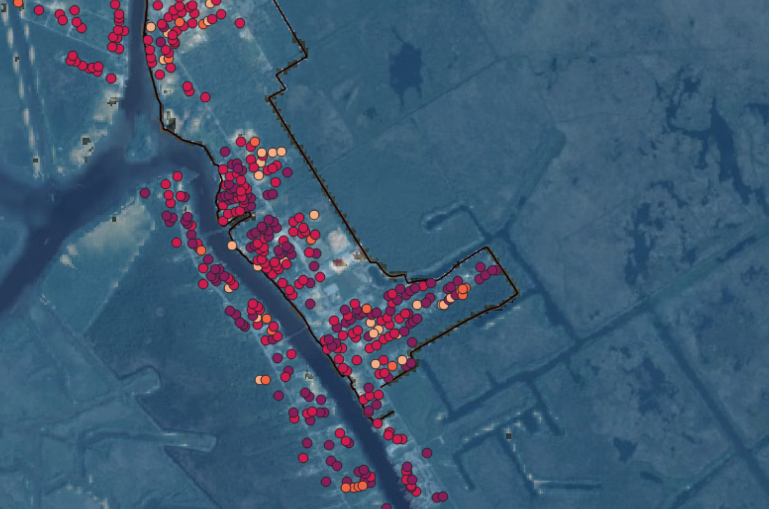 Satellite flood-risk heatmap with red and orange markers concentrated along a flooded coastal area