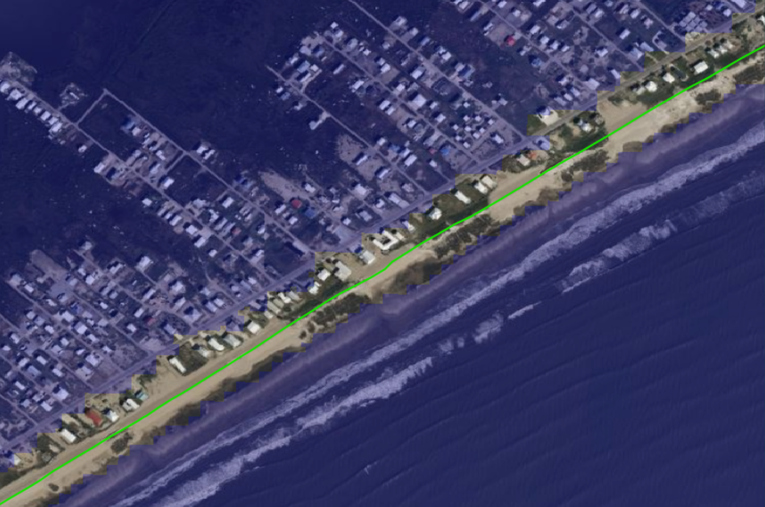 Satellite image of a coastal barrier island with a green line tracing the shoreline and nearby properties