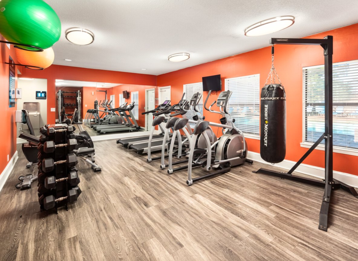 Fitness center with dumbbells and exercise equipment at The Landings at North Ingle