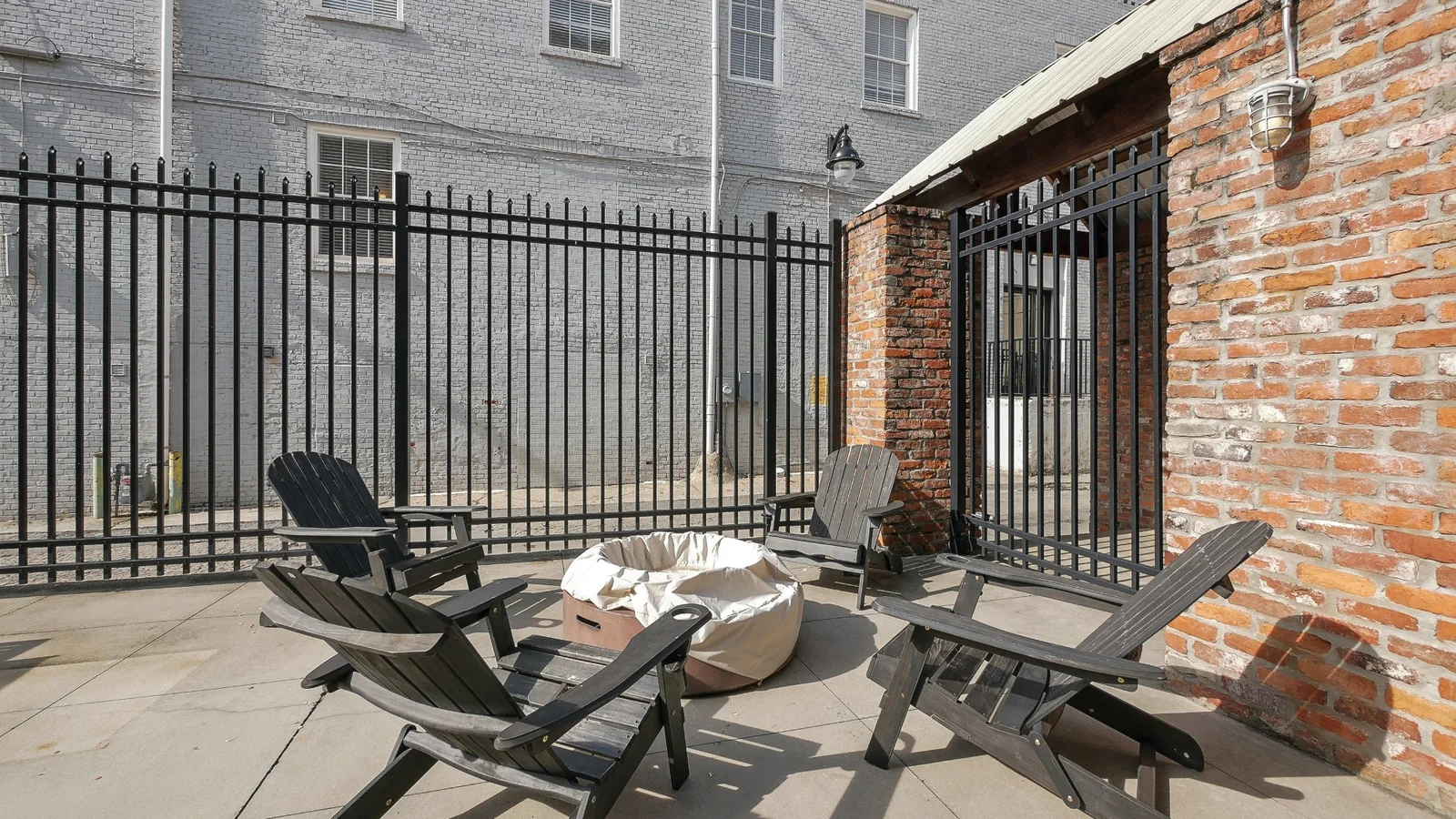 Courtyard fire pit with Adirondack chairs at The Lamar Lofts