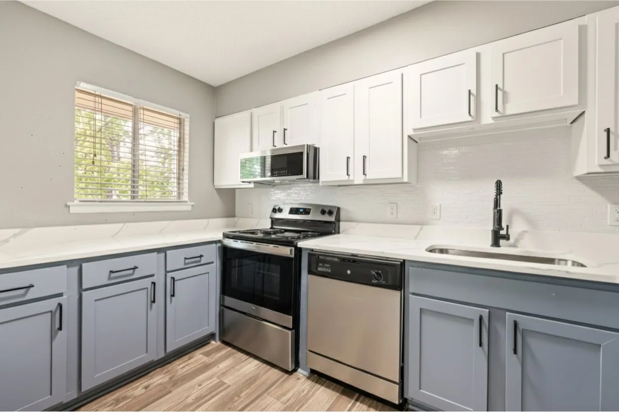 Renovated kitchen with two-tone cabinets at The Kenzie