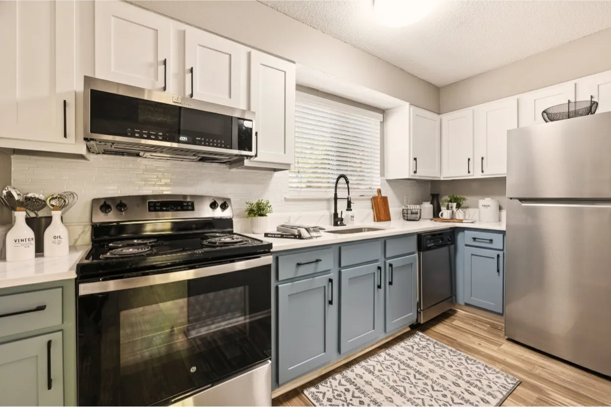 Staged kitchen with wide view and backsplash at The Kenzie