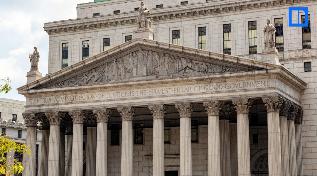 Neoclassical courthouse with columns and carved justice inscription, illustrating civics education for today’s classroom.