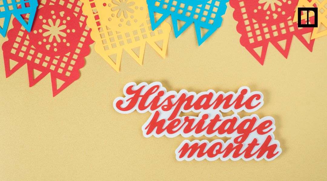 Colorful papel picado banners above red script text reading “Hispanic heritage month” on a tan background.