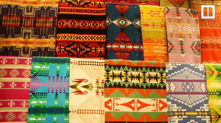 Colorful blankets with geometric patterns displayed in rows, featured in a Native American Heritage Month books blog for K–12 ELA.