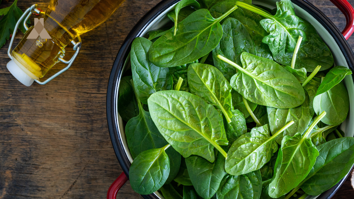 Fresh raw spinach leaves in a bowl — ingredient inspiration for Corazón by Baires’ signature side dishes.