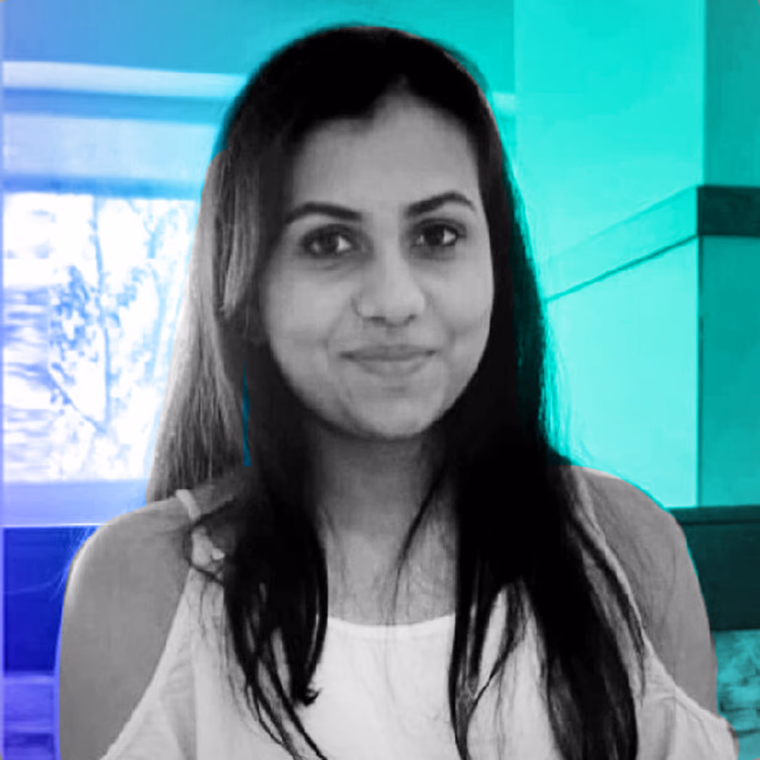 Smiling woman with long dark hair wearing a white top against a teal and blue background.