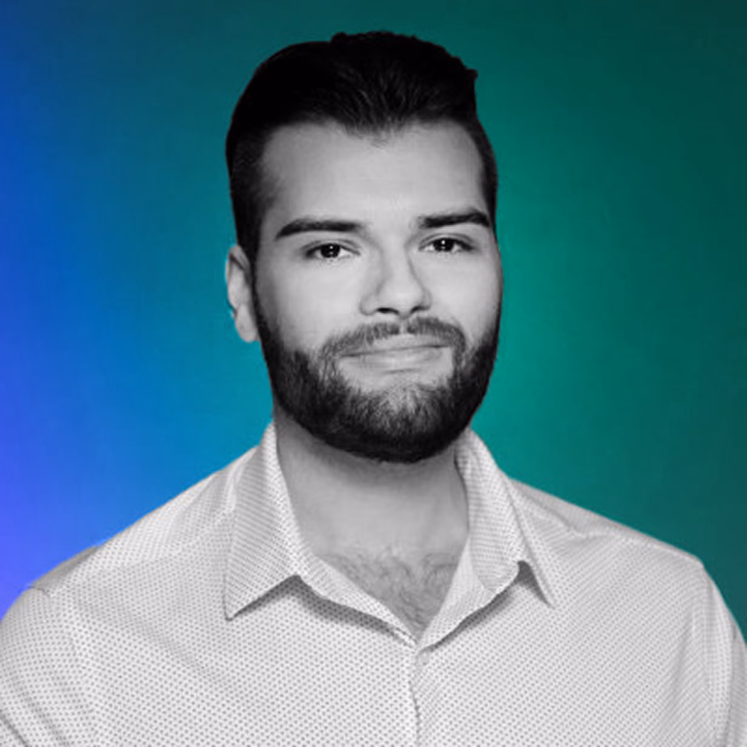 Man with dark hair and beard wearing a white patterned shirt against a blue and green gradient background.