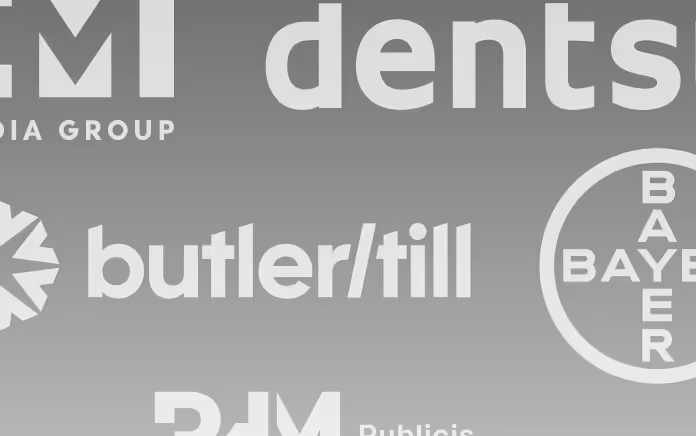 Partial view of logos including butler/till and Bayer on a gray gradient background.
