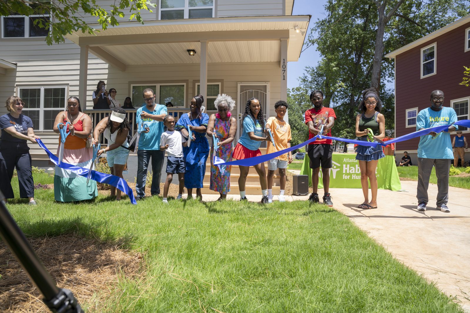 Homeowners and their families cut the ribbon at a Langston Park home dedication