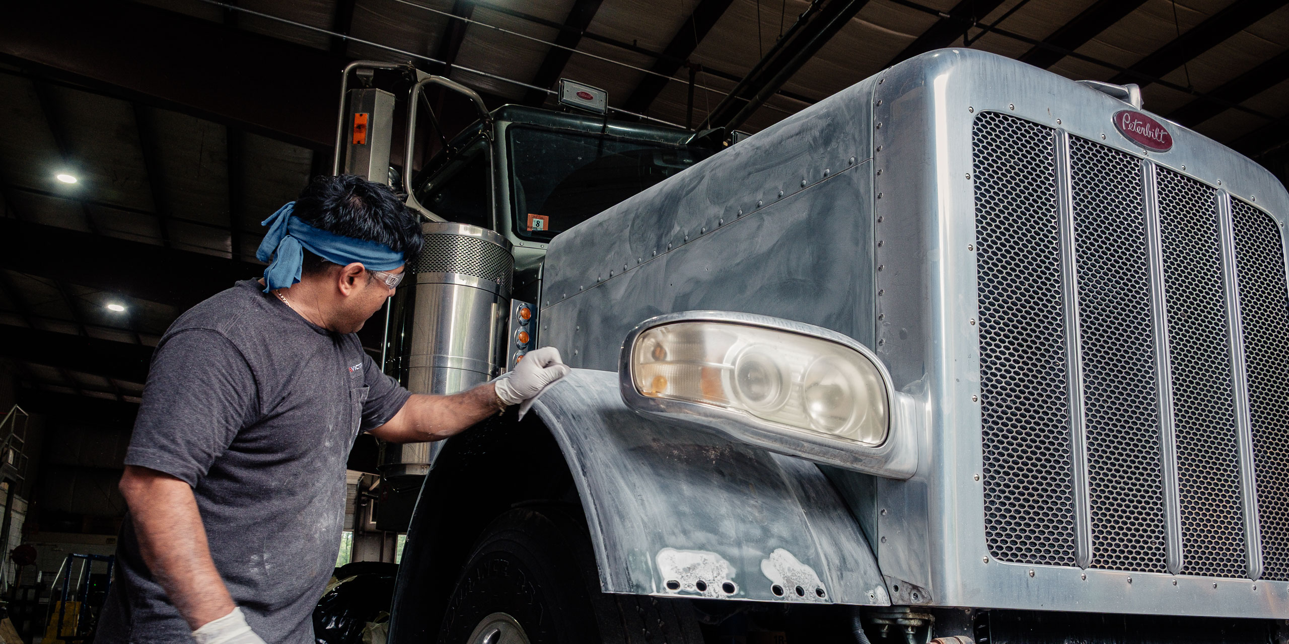 a semi tractor being sanded for paint