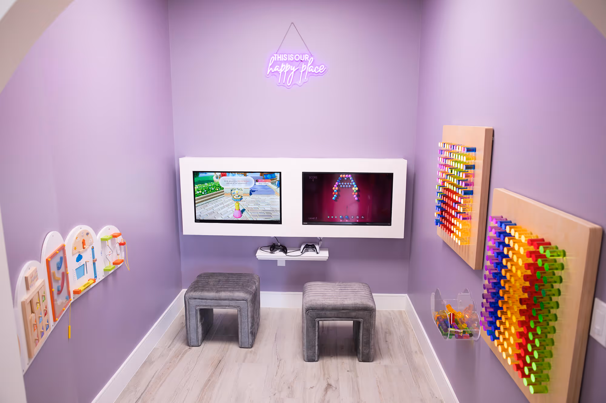 A child's playroom with two chairs and a television.