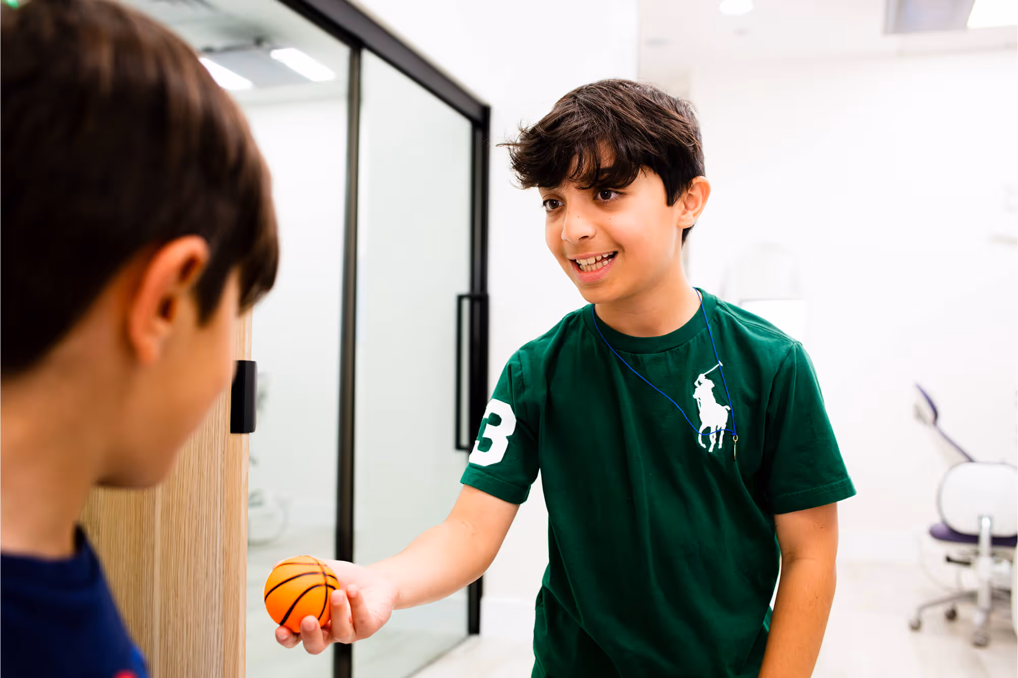A young boy holding a basketball in his hand.