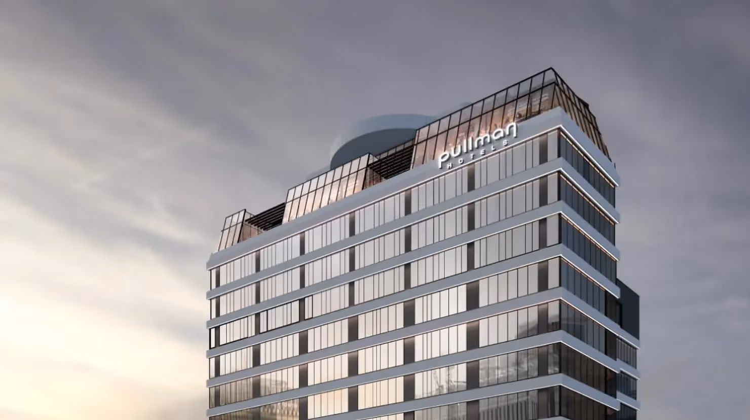 Alt text: "Modern Pullman hotel building in Hamilton with a sleek glass facade and contemporary design. Showcasing Hamilton's urban landscape and supporting local tourism and business growth."