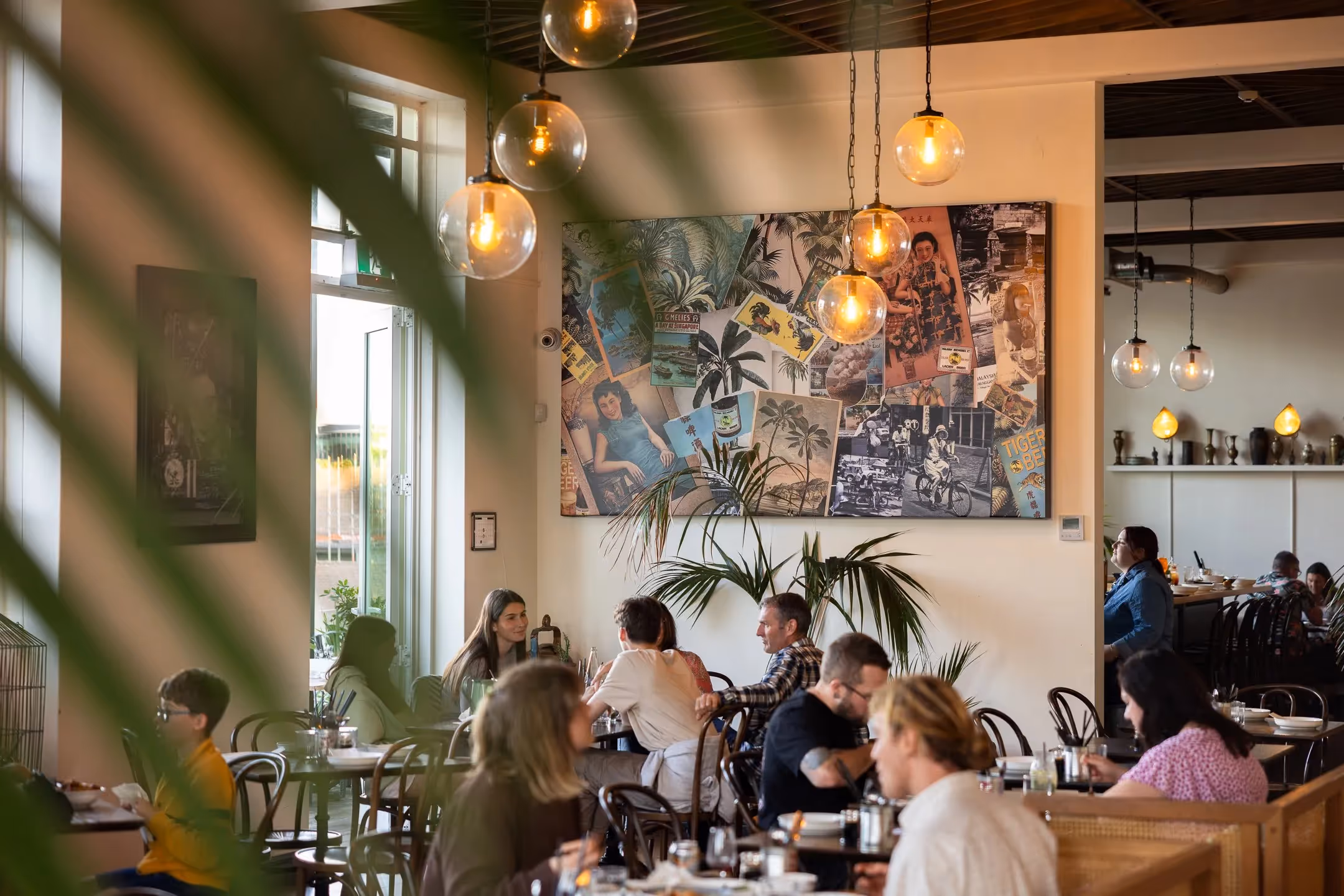 Alt text: A vibrant cafe in Hamilton featuring warm lighting, local artwork, and customers enjoying their meals, showcasing the city’s community spirit and support for local businesses. Ideal for Love the Centre's celebration of Hamilton's heart.