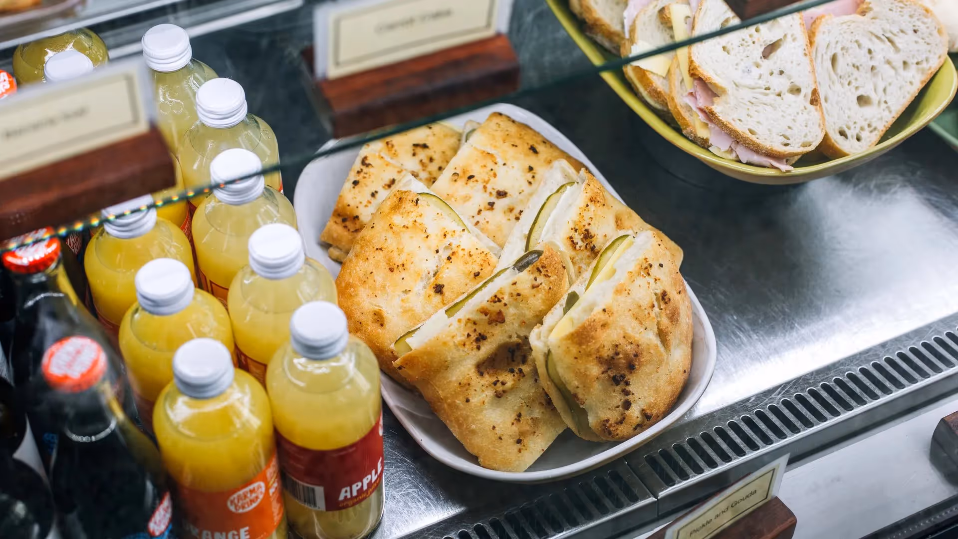 Delicious freshly baked pastries on display at a local Hamilton café, surrounded by refreshing beverage options. Showcasing the best of Hamilton's food scene and supporting local businesses. Perfect for a community snack experience.