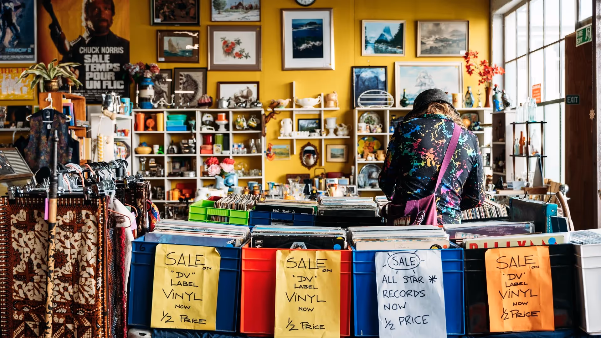 A vibrant vintage shop in Hamilton showcasing a variety of vinyl records and eclectic items. Shoppers explore unique finds amidst colourful decor, highlighting local businesses and community engagement. Perfect for vinyl enthusiasts and treasure hunters.