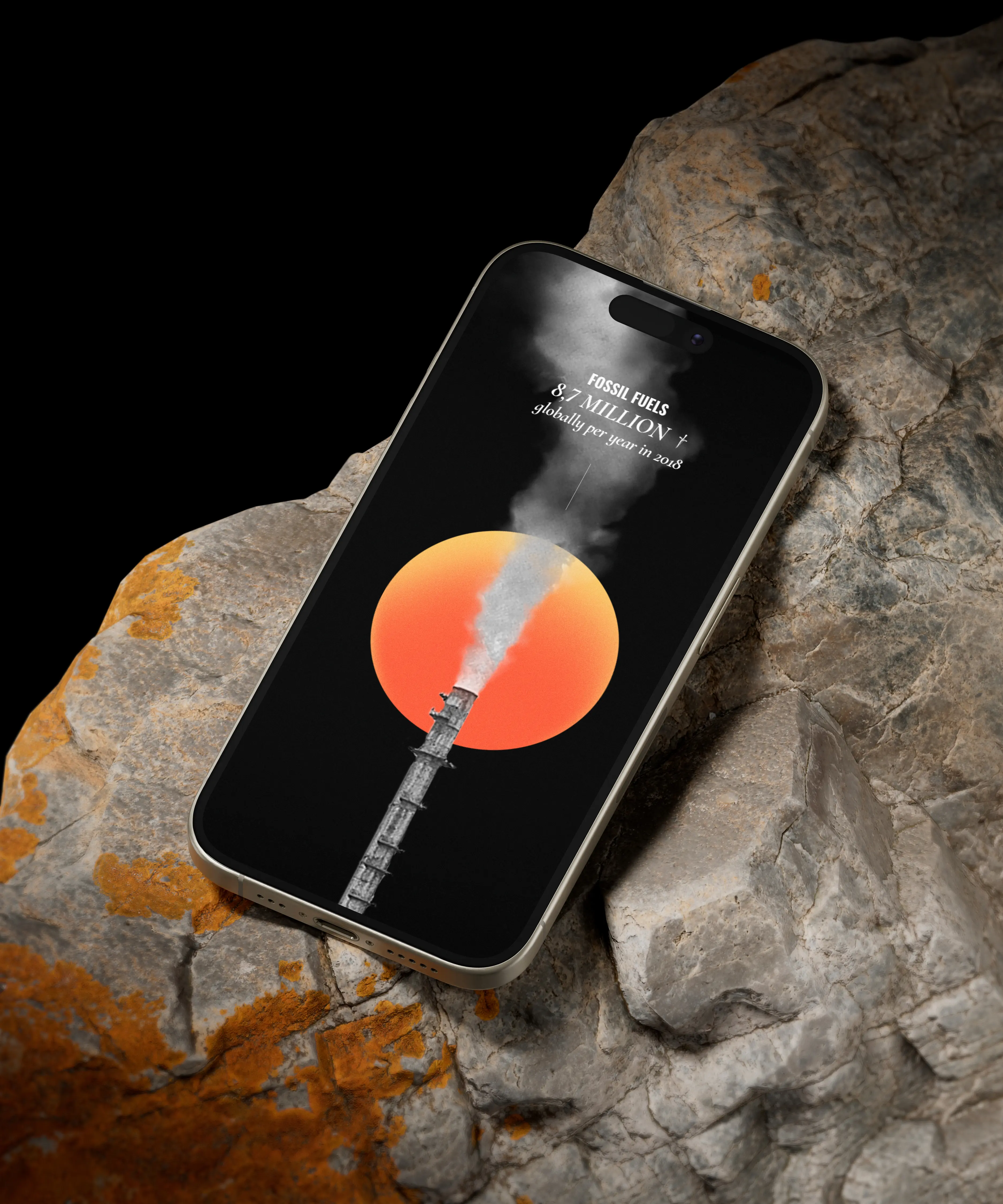 A smartphone on weathered rock with orange lichen shows fossil fuel emissions data. The screen displays a smokestack, orange circle, and text reading fossil fuels 8.7 million globally per year in 2018.