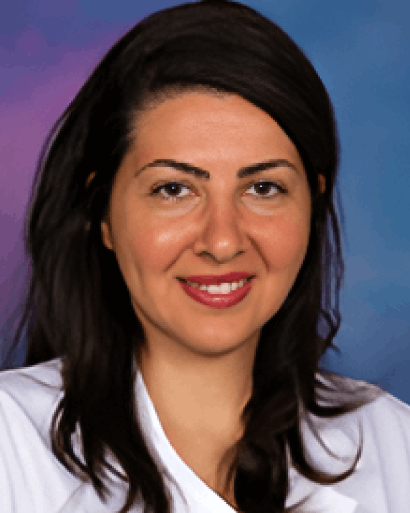 Portrait of a smiling woman with long dark hair wearing a white top, set against a blue and purple gradient background.